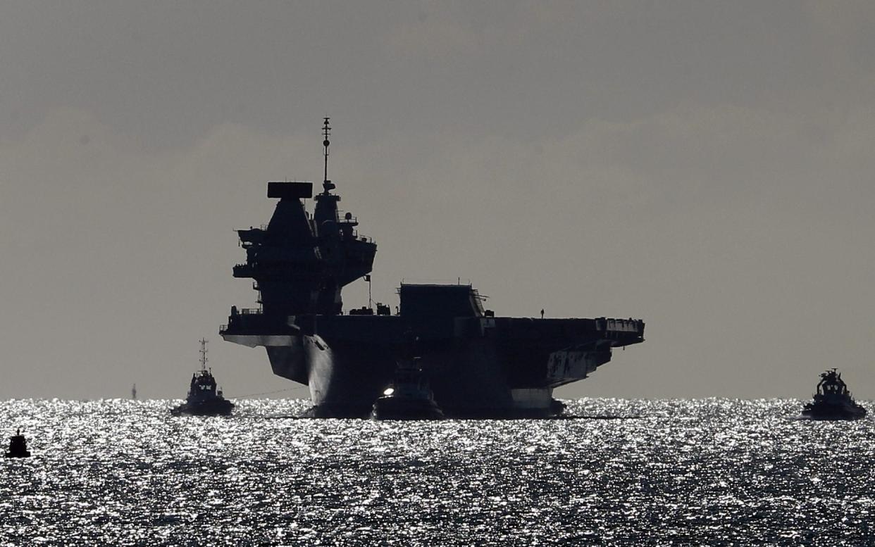 The Royal Navy aircraft carrier HMS Queen Elizabeth arrives back at Portsmouth Naval Base after taking part in exercises off Scotland - Gareth Fuller/PA
