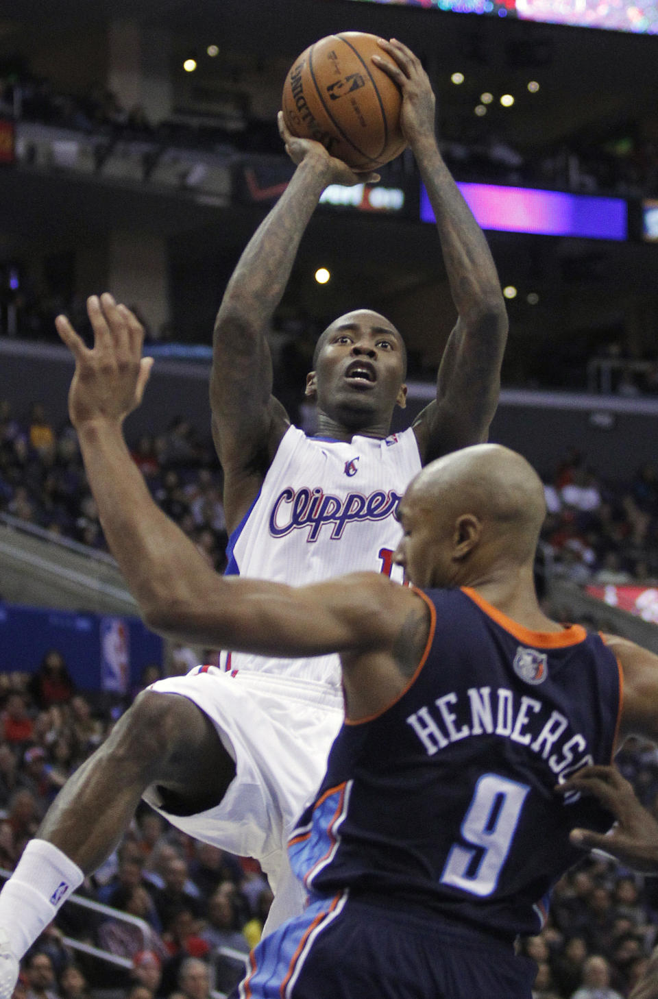 Los Angeles Clippers guard Jamal Crawford, left, shoots over Charlotte Bobcats guard Gerald Henderson (9) during the first half of an NBA basketball game Wednesday, Jan. 1, 2014, in Los Angeles. (AP Photo/Alex Gallardo)