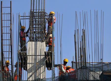 Labourers work at the site of a monorail project in Mumbai February 27, 2015. REUTERS/Shailesh Andrade