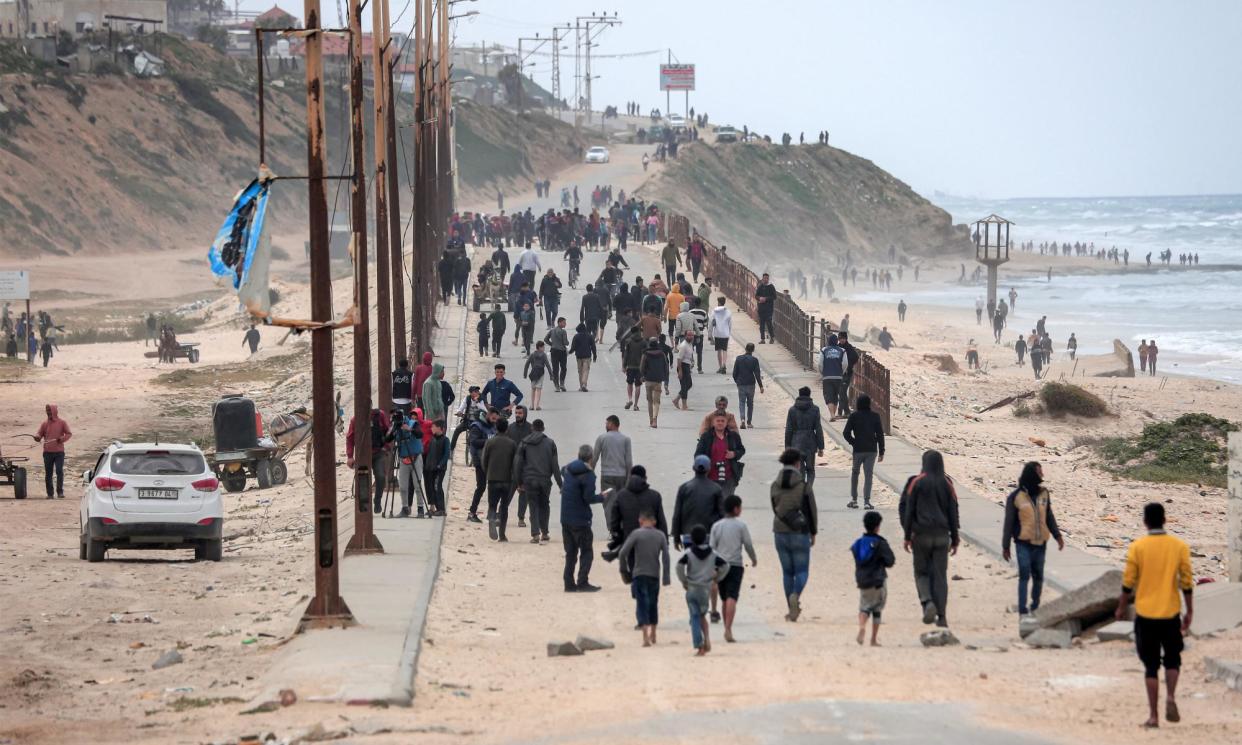 <span>Displaced Palestinians told to flee from the area around al-Shifa hospital walk along a coastal road towards the Nuseirat refugee camp in Gaza.</span><span>Photograph: AFP/Getty Images</span>