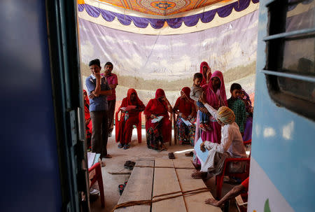 Patients and their relatives wait before the start of a cataract surgery on the Lifeline Express, a hospital built inside a seven-coach train, at a railway station in Jalore, India, April 2, 2018. REUTERS/Danish Siddiqui