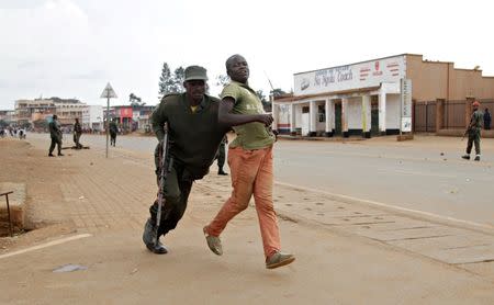 A Congolese soldier arrests a civilian protesting against the government's failure to stop the killings and inter-ethnic tensions in the town of Butembo, North Kivu province in the Democratic Republic of Congo, August 24, 2016. REUTERS/Kenny Katombe