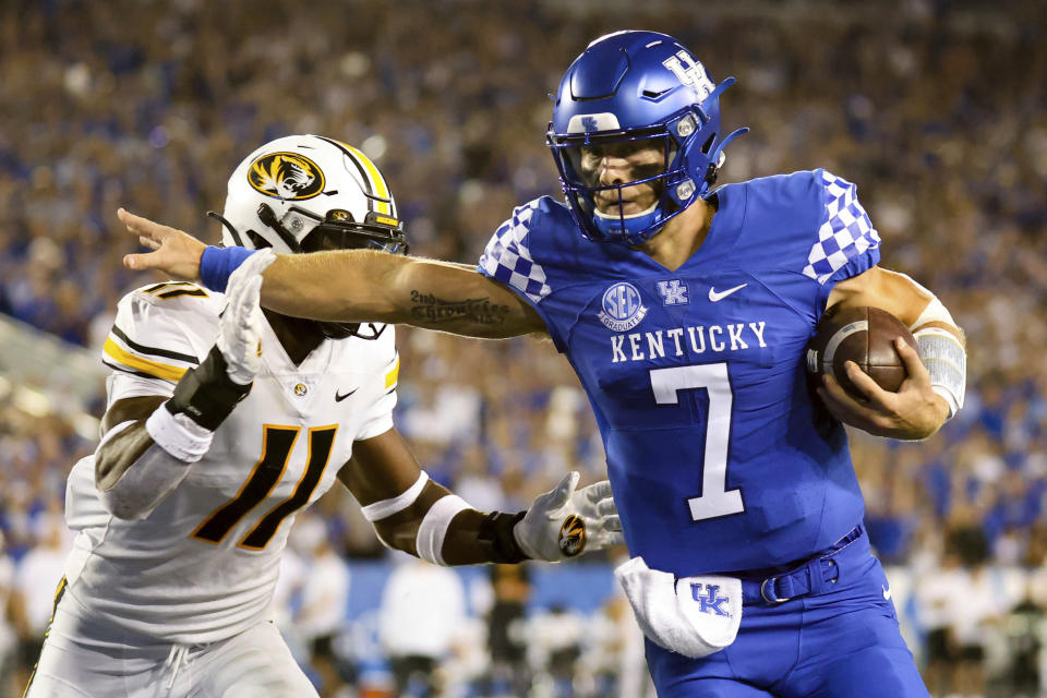 Kentucky quarterback Will Levis (7) stiff arms Missouri linebacker Devin Nicholson (11) on his way into the end zone during the first half of an NCAA college football game against Missouri in Lexington, Ky., Saturday, Sept. 11, 2021. (AP Photo/Michael Clubb)