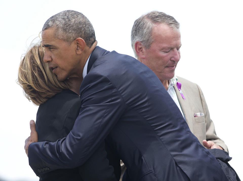 <p>President Obama hugs Orange County Mayor Teresa Jacobs, accompanied by Orlando, Mayor Buddy Dyer, right, on the tarmac upon his arrival at Orlando International Airport, June 16, 2016. (AP/Pablo Martinez Monsivais) </p>