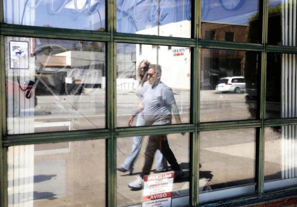 Two women walk the streets of Pasadena.