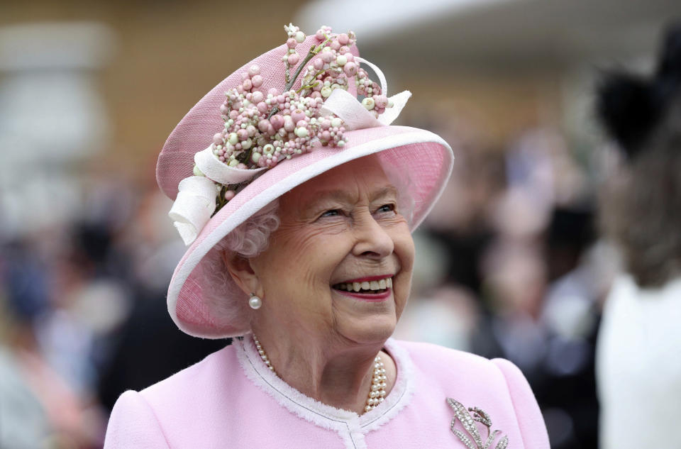 FILE - Britain's Queen Elizabeth arrives for a Royal Garden Party at Buckingham Palace in London, Wednesday, May 29, 2019. Queen Elizabeth II will mark 70 years on the throne Sunday, Feb. 6, 2022, an unprecedented reign that has made her a symbol of stability as the United Kingdom navigated an age of uncertainty. (Yui Mok/Pool Photo via AP, File)