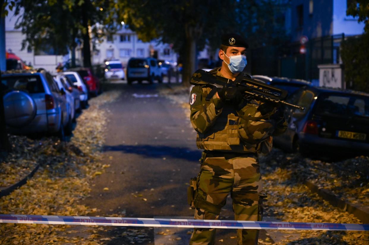 A French soldier stands behind a cordon on Saturday in Lyon near the scene where an attacker armed with a sawn-off shotgun wounded an Orthodox priest (AFP via Getty Images)