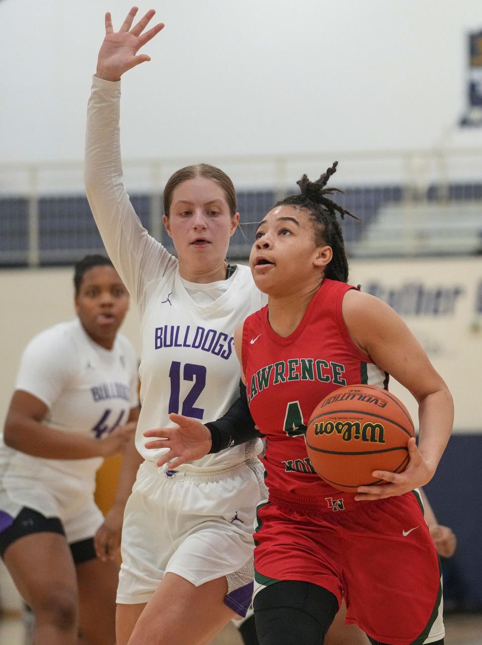 Lawrence North Wildcat Kya Hurt (4) drives to the basket, guarded by Brownsburg Bulldog Megan Eaker (12), Saturday, Feb. 11, 2023, during IHSAA 4A regionals at Decatur Central in Indianapolis. Lawrence North defeated Brownsburg, 65-58, advancing to semi-state. 