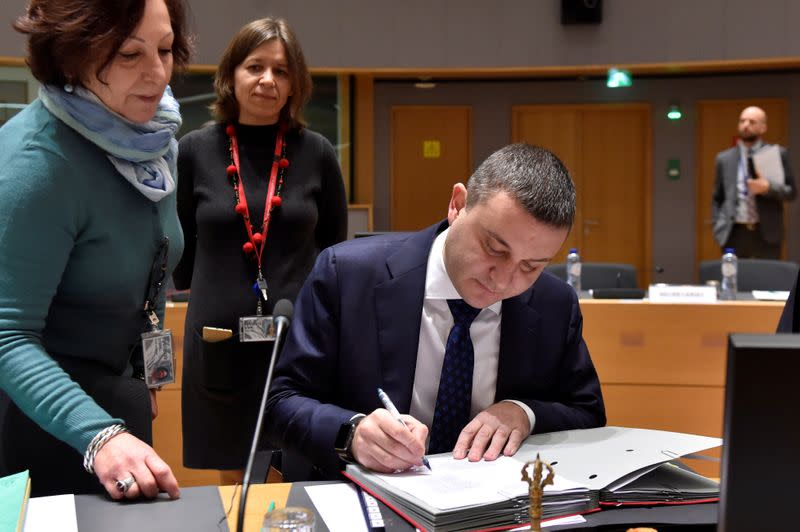 FILE PHOTO: Bulgaria's minister of finance Vladislav Goranov signs documents as he attends a European Union finance ministers meeting in Brussels