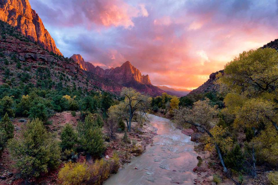 <p>Justin Reznick/Getty Images</p> Sunset over the Virgin River in Zion National Park. 