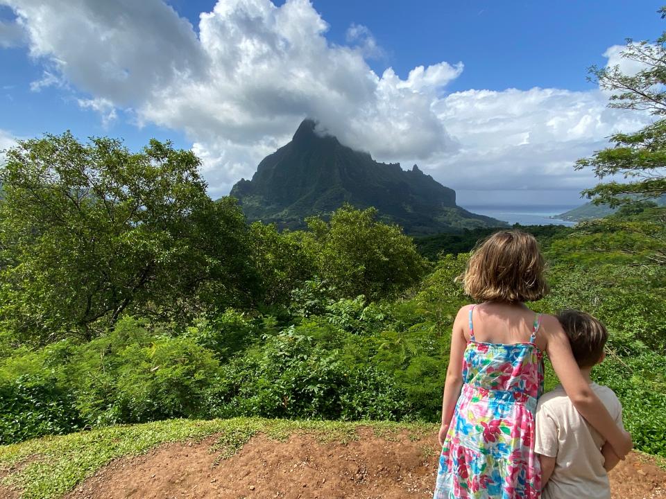 Two children looking out at mountains.