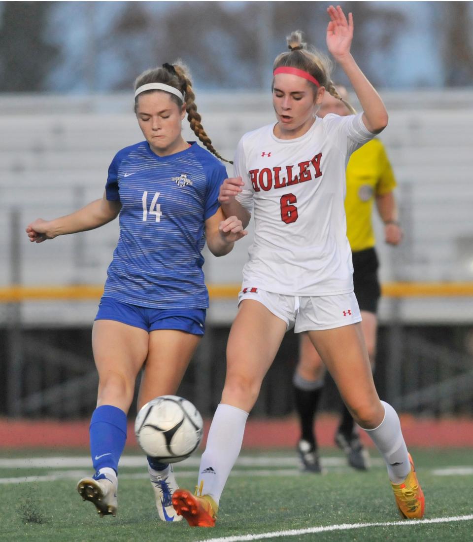 Geneseo's Lily Weber (14) and Holley's Jailyn Bishop battle for possession during Tuesday's Class C1 semifinal.