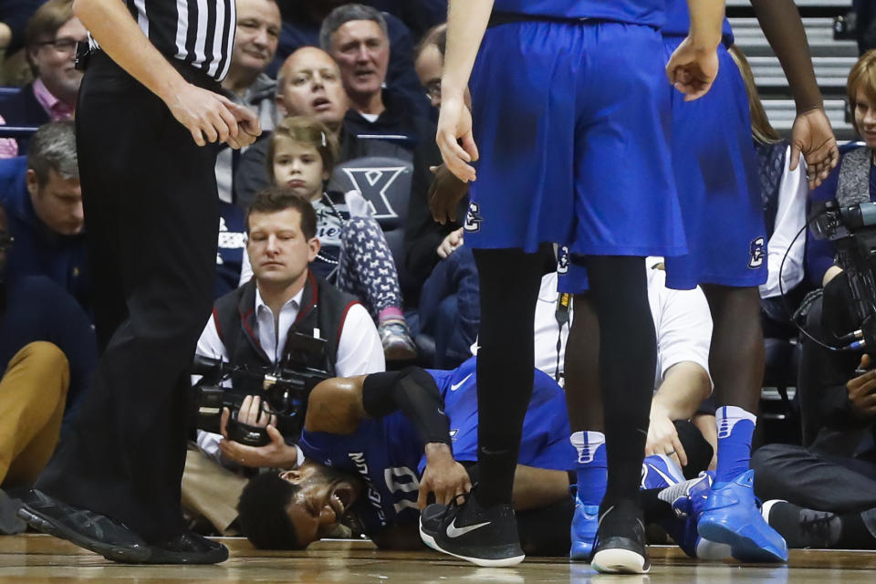 Creighton's Maurice Watson Jr. (10) winces in pain after injuring his knee in the first half of an NCAA college basketball game against Creighton, Monday, Jan. 16, 2017, in Cincinnati. (AP Photo/John Minchillo)