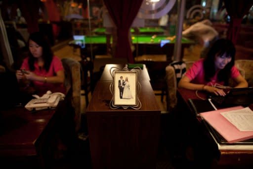 Staff members are seen at a singles club in Beijing. A 2010 survey showed that there were 180 million single men and women in China -- out of a population of 1.3 billion people -- and that 92 percent of men questioned believed that a woman should be married before the age of 27