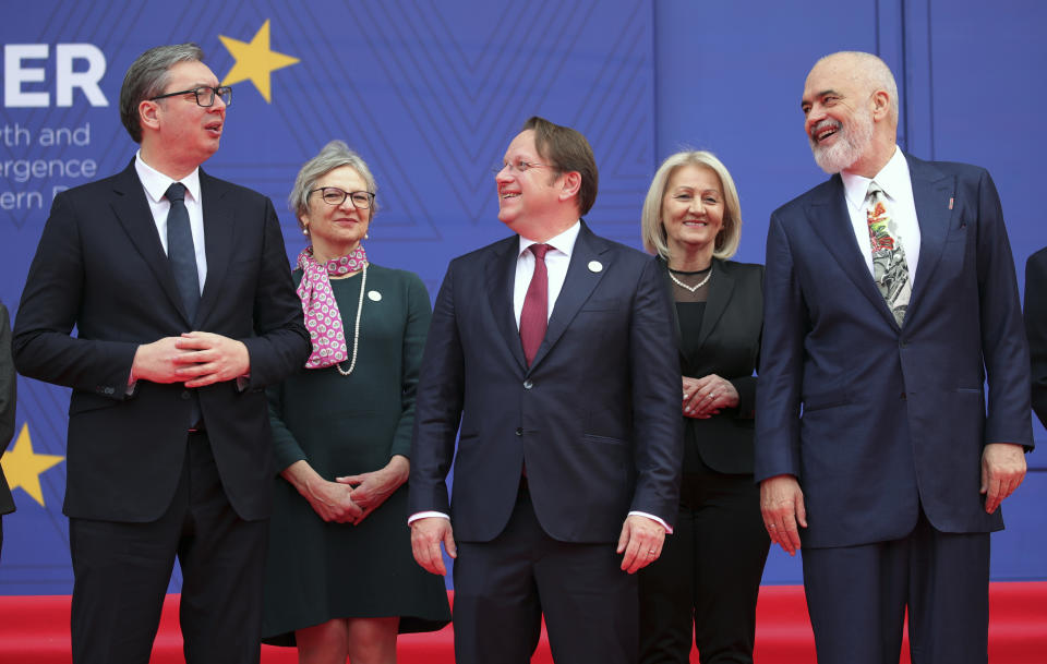 Serbia's President Aleksandar Vucic, left, European Commissioner for Neighbourhood and Enlargement Oliver Varhelyi, center, and Albania's Prime Minister Edi Rama, right, talk during a family photo in Tirana, Albania, Thursday, Feb. 29, 2024. The leaders of Western Balkan countries met Thursday in another joint push to use the European Union's financial support plan of six billion euros (about $6.5 billion) hoping it will speed up its membership in the bloc. (AP Photo/Armando Babani)