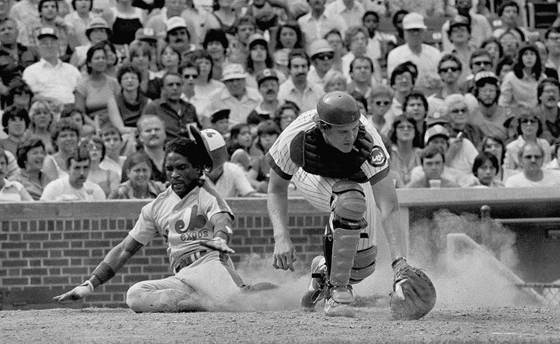 Montreal Expos Tim Raines, left, slides home safely as Chicago Cubs catcher Jody Davis, right, snags a late throw during fifth inning action at Chicago, Sept. 13, 1981. Raines came home on a hit by Andre Dawson. The Expos won 10-6. (AP Photo/Fred Jewell)