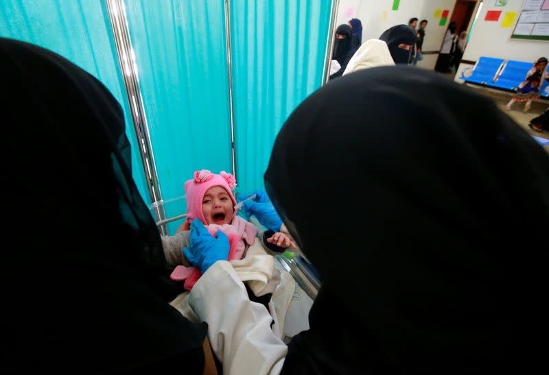 Girl cries as she is administered with a polio vaccine during a three-day immunization campaign in Sanaa