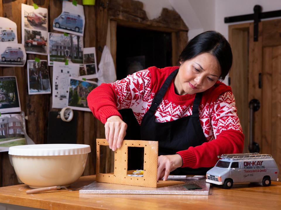 Cake designer Michelle Wibowo works on her gingerbread version of the McCallister house