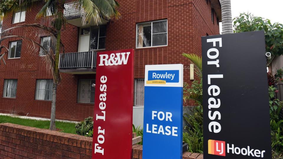 A block of units with lease signs out front.