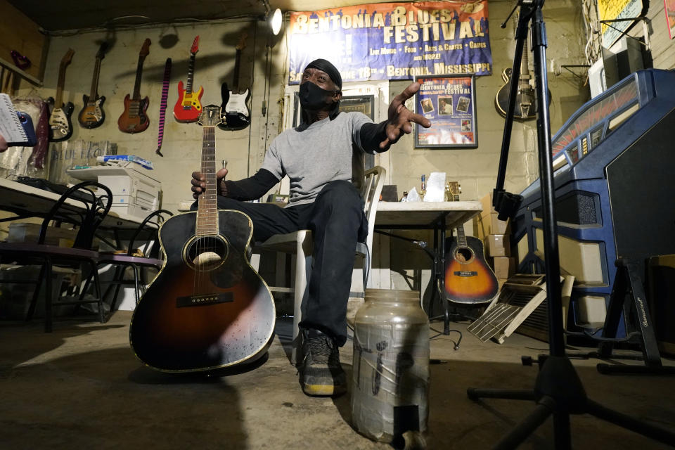 Bluesman Jimmy "Duck" Holmes gestures as he speaks of the area musicians he learned the style of the Bentonia Blues from at his Blue Front Cafe in Bentonia, Miss., Jan. 21, 2021. Holmes' ninth album, "Cypress Grove," has earned a Grammy nomination for the Best Traditional Blues Album. (AP Photo/Rogelio V. Solis)