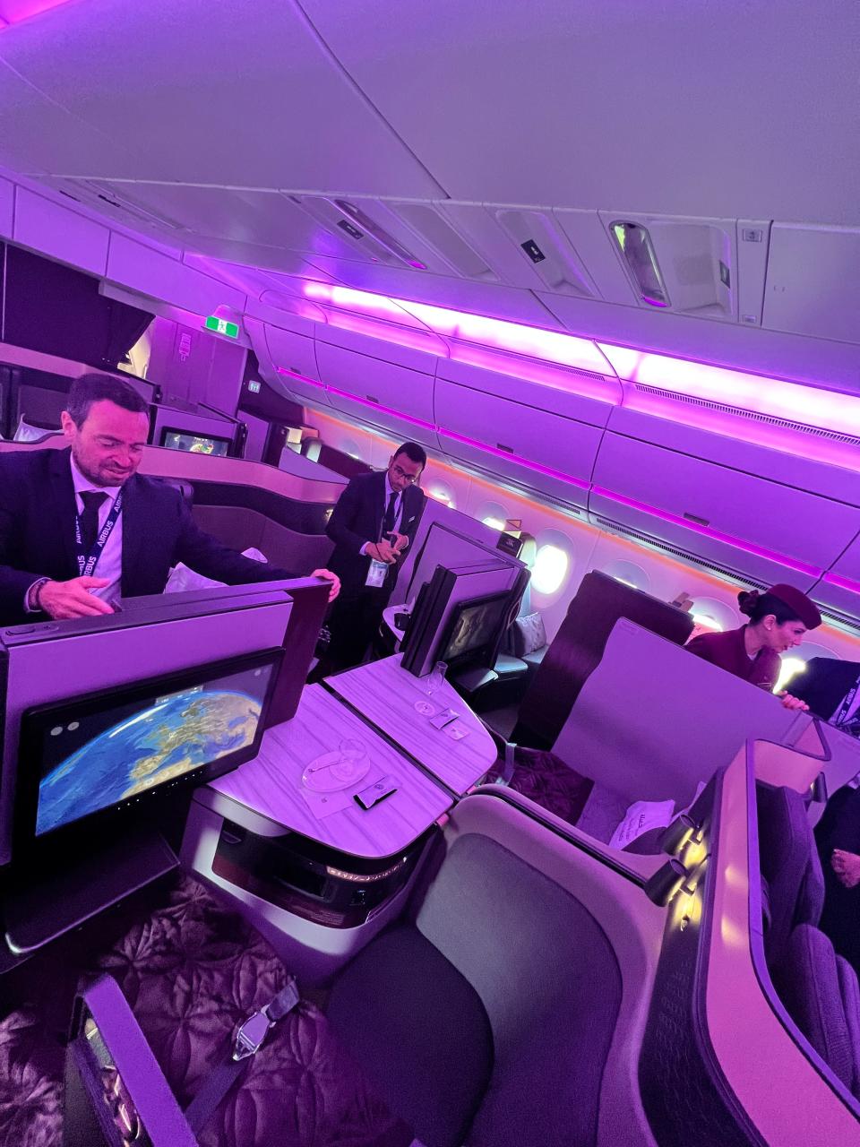 An Airbus spokesperson demonstrates how the Qatar business class seats can be opened up to create a quad section