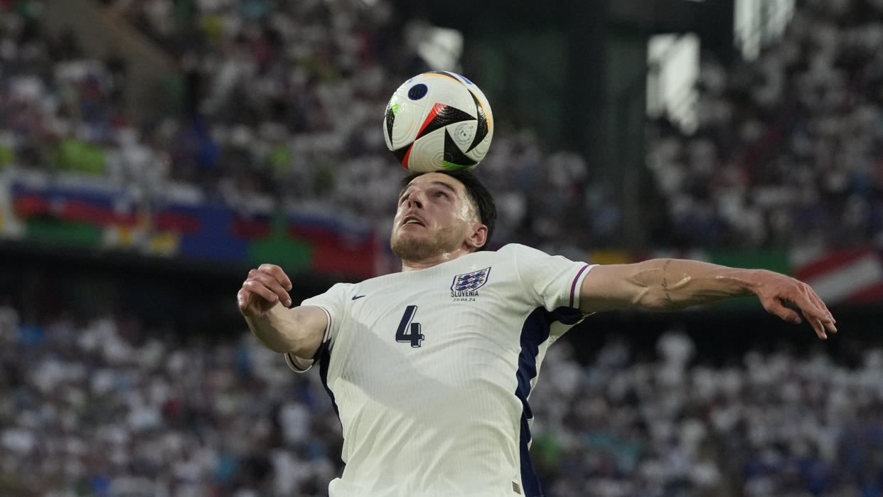 England's Declan Rice heads the ball during a Group C match between the England and Slovenia at the Euro 2024 soccer tournament in Cologne, Germany, Tuesday, June 25, 2024. (AP Photo/Frank Augstein)