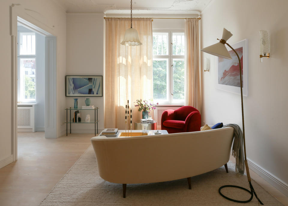 Minimalist living room with red sofa and frame tv