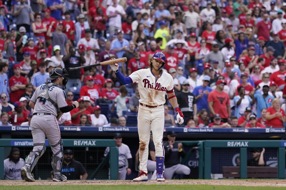 Philadelphia Phillies' Alec Bohm, right, reacts after striking out with the bases loaded against Miami Marlins pitcher David Robertson during the seventh inning of a baseball game, Sunday, Sept. 10, 2023, in Philadelphia. (AP Photo/Matt Slocum)