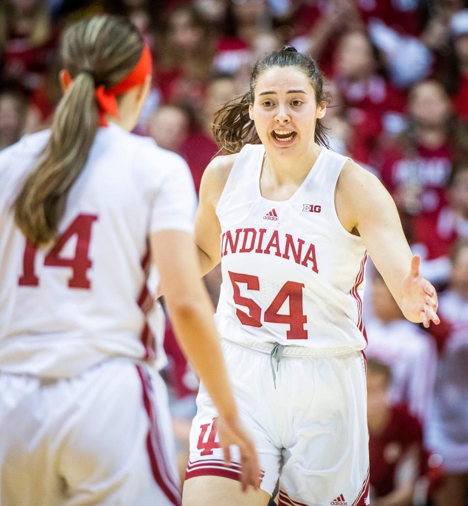 Indiana's Mackenzie Holmes (54) thanks Sara Scalia (14) for the assist after her basket during the first half of the Indiana versus Purdue women's basketball game at Simon Skjodt Assembly Hall on Sunday, Feb. 19, 2023.