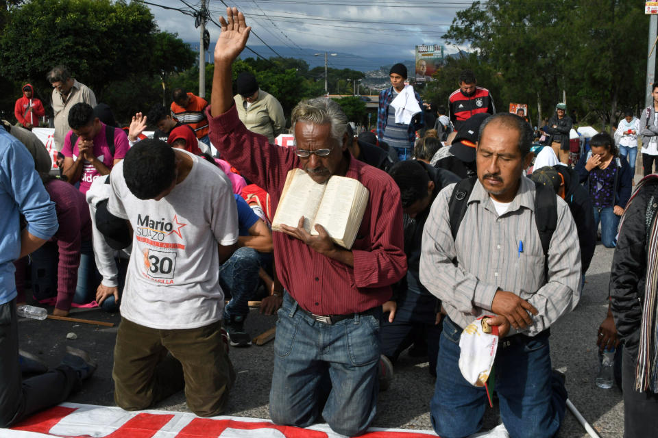 <p>Supporters of Honduran presidential candidate for the Opposition Alliance against the Dictatorship party Salvador Nasralla, kneel to pray during a protest near the Electoral Supreme Court (TSE), to demand the announcement of the election final results in Tegucigalpa, on Nov. 30, 2017. (Photo: Orlando Sierra/AFP/Getty Images) </p>