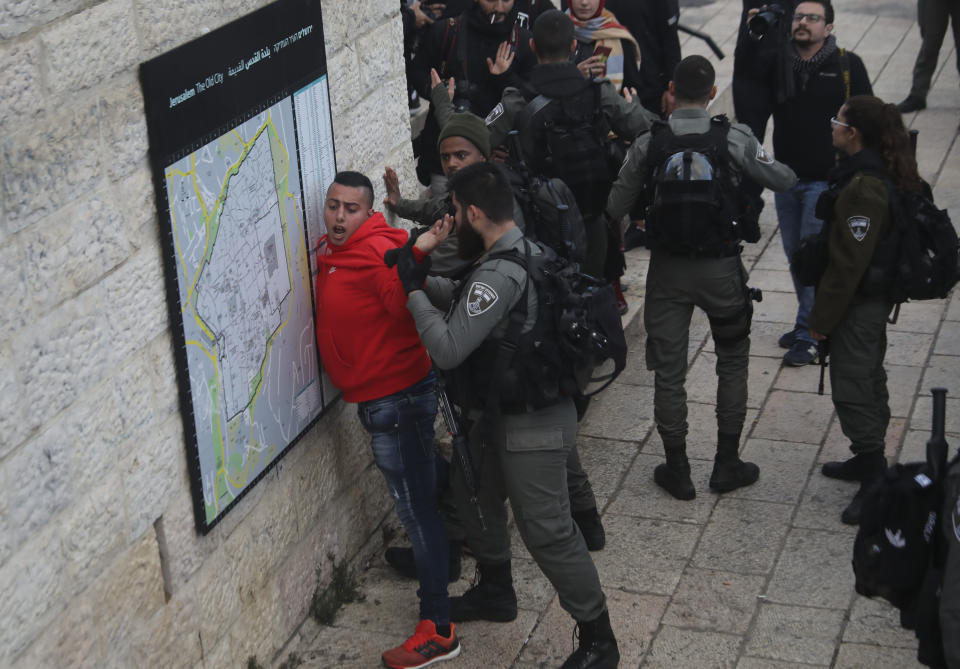 Israeli border police frisks a Palestinian ahead of a protest against Middle East peace plan announced Tuesday by US President Donald Trump, which strongly favors Israel, in Jerusalem, Wednesday, Jan 29, 2020. (AP Photo/Mahmoud Illean)