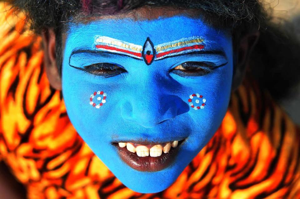 <p>A child dressed as the Hindu god Shiva peers into the camera at Sangam, the confluence of River Ganga, Yamuna and Mythological Saraswati. (Prabhat Kumar Verma/Pacific Press/LightRocket via Getty Images)</p>