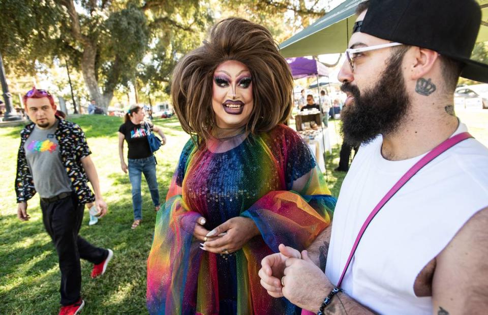 MC Sasha Devaroe, middle, and her husband Larry Soria, right, attend the MoPride festival at Graceada Park in Modesto, Calif., Saturday, Oct. 1, 2022.