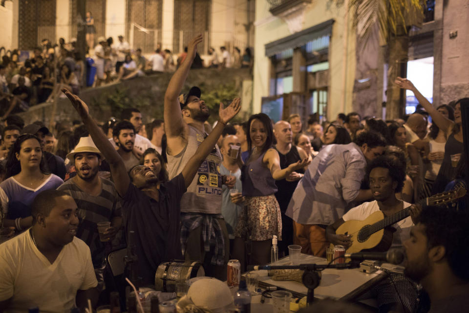 This Sept. 7, 2012 photo shows people gathering to listen to live Samba music in a plaza called "Pedra do Sal", or "Stone of Salt" in Rio de Janeiro, Brazil. Rio's signature percussion-driven rhythm can be heard in classy indoor music venues, sure, but old-school samba circles can pop up without notice. (AP Photo/Felipe Dana)