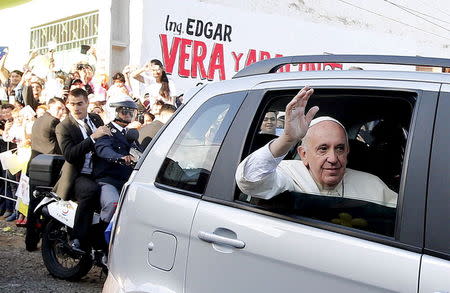 Pope Francis waves as he arrives to visit the Banado Norte neighborhood in Asuncion, Paraguay, July 12, 2015. REUTERS/Alessandro Bianchi