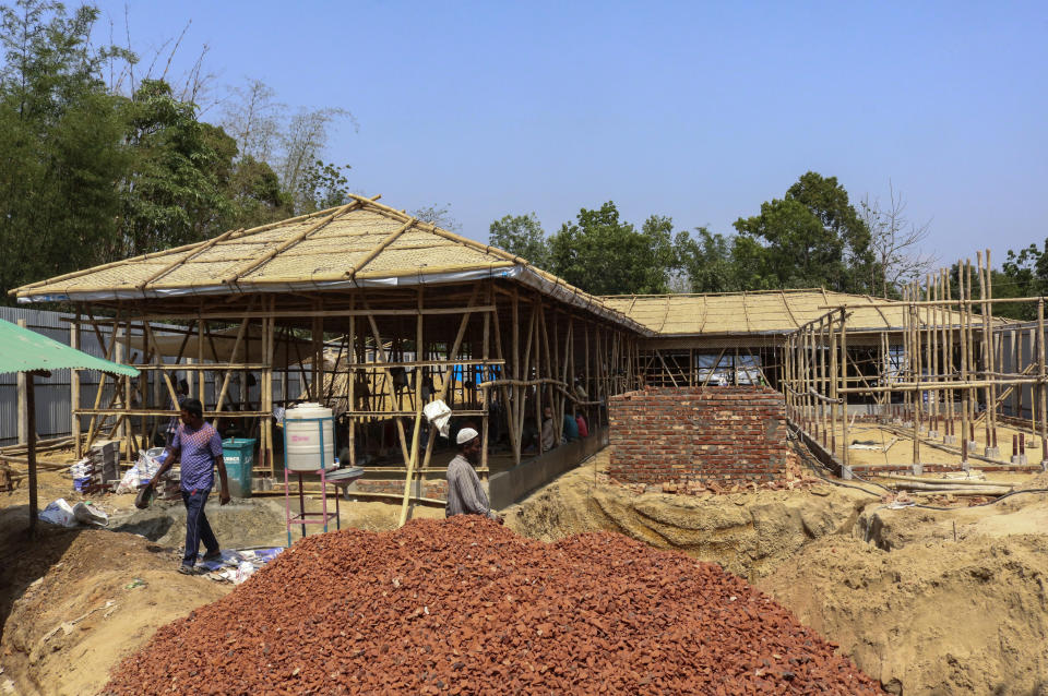 This April 16, 2020 photograph shows the construction of a COVID-19 isolation ward and treatment center by the UNHCR at the Kutupalong refugee camp in Cox's Bazar, Bangladesh. The rapid spread of the coronavirus has raised fears about the world’s refugees and internally displaced people, many of whom live in war-ravaged countries that are ill-equipped to test for the virus or contain a possible outbreak. (AP Photo/Shafiqur Rahman)