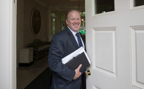 Former White House press secretary Sean Spicer stands in the doorway to the Palm Room at the White House in Washington, Friday, Aug. 11, 2017, during renovations to the West Wing - Credit: AP