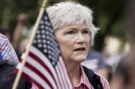 A person stands as the national anthem plays during a rally near the U.S. Capitol in Washington, Saturday, Sept. 18, 2021. The rally was planned by allies of former President Donald Trump and aimed at supporting the so-called "political prisoners" of the Jan. 6 insurrection at the U.S. Capitol. (AP Photo/Brynn Anderson)