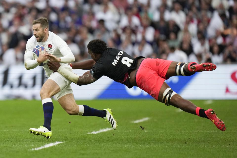 England's Elliot Daly, left, is tackled by Fiji's Viliame Mata during the Rugby World Cup quarterfinal match between England and Fiji at the Stade de Marseille in Marseille, France, Sunday, Oct. 15, 2023. (AP Photo/Pavel Golovkin)