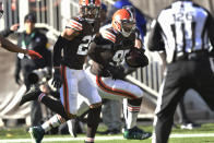 Cleveland Browns defensive end Myles Garrett (95) runs in for a touchdown during the first half of an NFL football game against the Baltimore Ravens, Sunday, Dec. 12, 2021, in Cleveland. (AP Photo/David Richard)