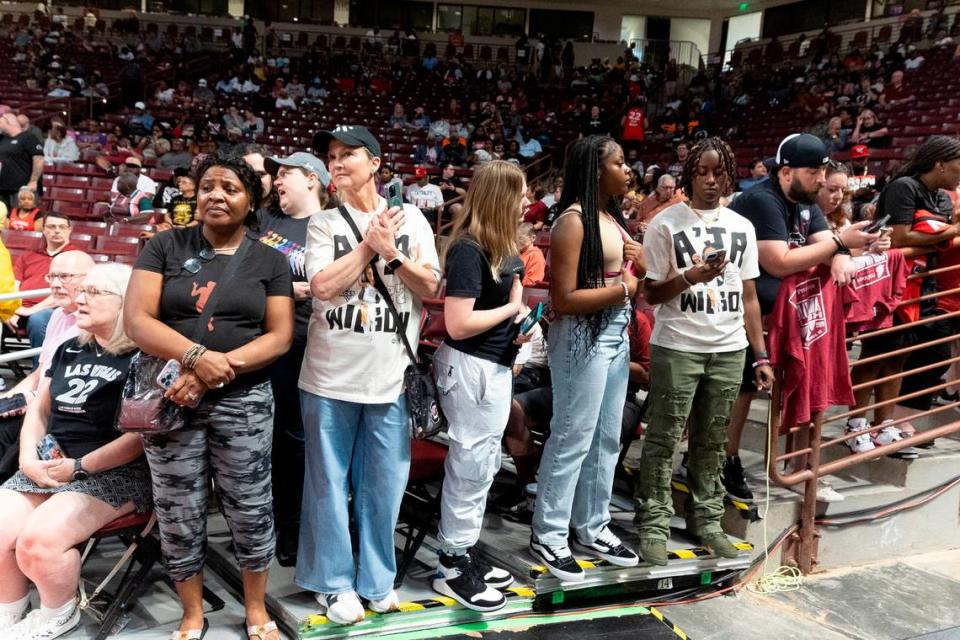 Dayle Sanders of Blythewood, second from left, waits to photograph the Las Vegas Aces as they arrive on court in the Colonial Life Arena. Tracy Glantz/tglantz@thestate.com