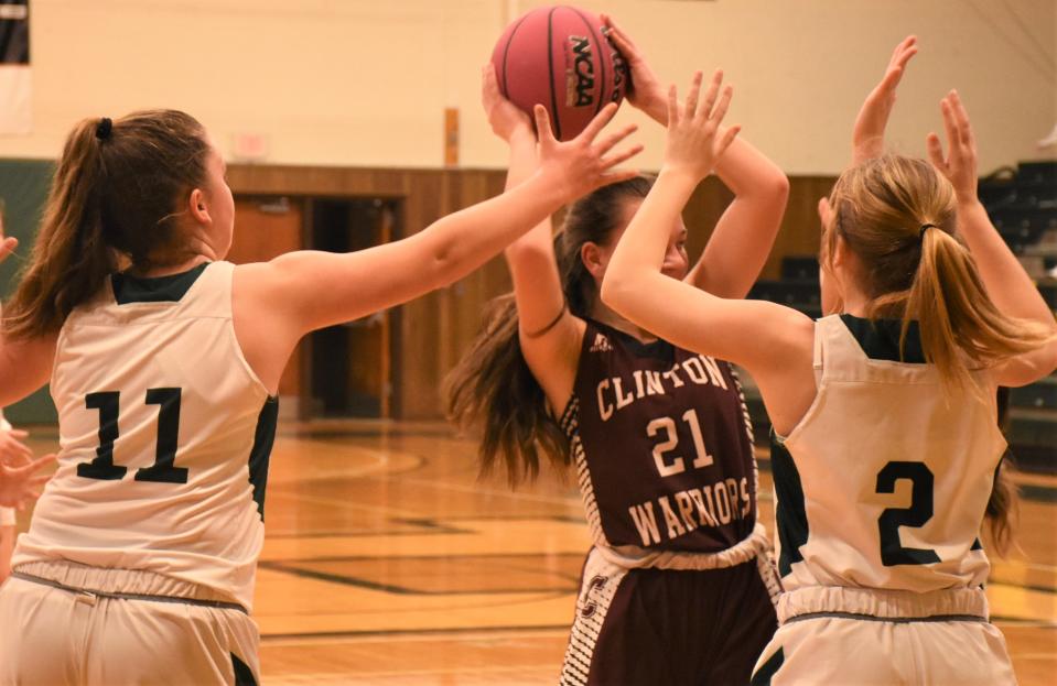 Westmoreland Bulldogs Julianna Otis (11) and Jacqueline Downs (2) swarm Clinton Warrior Eva Gaetano during the Utica Board of Officials for Women's Basketball Cancer Challenge Sunday in Herkimer.