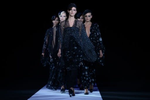 Models walk the runway at the Giorgio Armani show on September 23 during Milan fashion week. The hotly-awaited Armani collection ranged from sleek silk suits in subtle tones to a series of glittering eveningwear creations