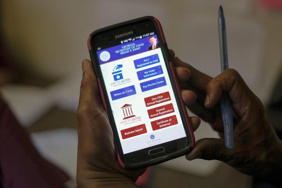 The Georgia SOS app is used by members of Women on the Move to confirm registration and polling precincts with callers at the Urban League of Greater Columbus in Columbus, Ga. on election day, Nov. 6, 2018.