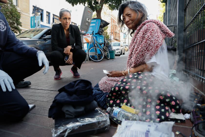 San Francisco District Attorney Brooke Jenkins speaks with Maria Araneda, 64