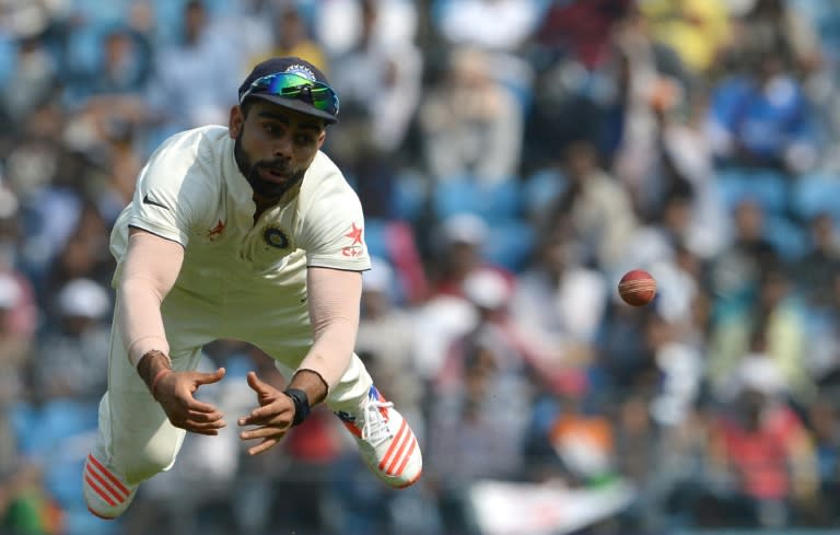 India's captain Virat Kohli dives in air to take a catch on the third day of the third Test cricket match between India and South Africa at The Vidarbha Cricket Association Stadium in Nagpur on November 27, 2015