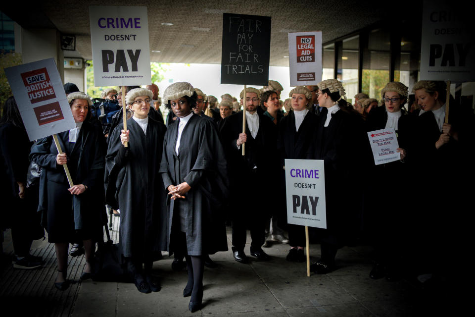 Criminal barristers from the Criminal Bar Association (CBA), which represents barristers in England and Wales, outside Manchester Crown Court on the first of several days of court walkouts by CBA members in a row over legal aid funding.Picture date: Monday June 27, 2022.