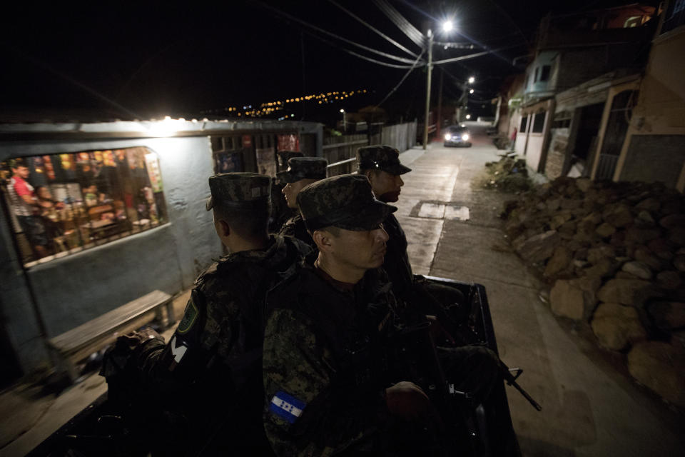 Soldiers patrol Tegucigalpa, Honduras, late Wednesday, Aug. 21, 2019. Honduras' murder rate fell from a dizzyingly high of 86.5 per 100,000 residents in 2011 to 41.4 last year. (AP Photo/Eduardo Verdugo)