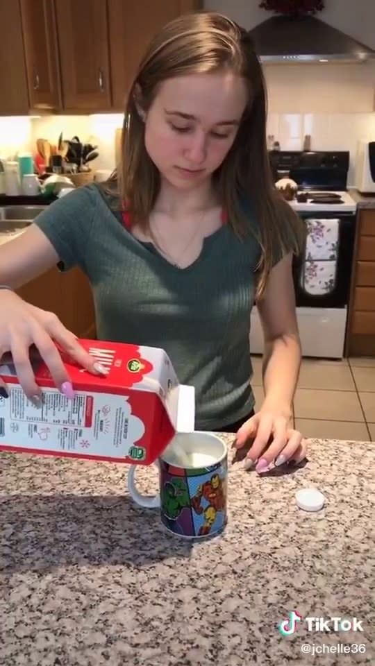 Girl pouring milk into hot water