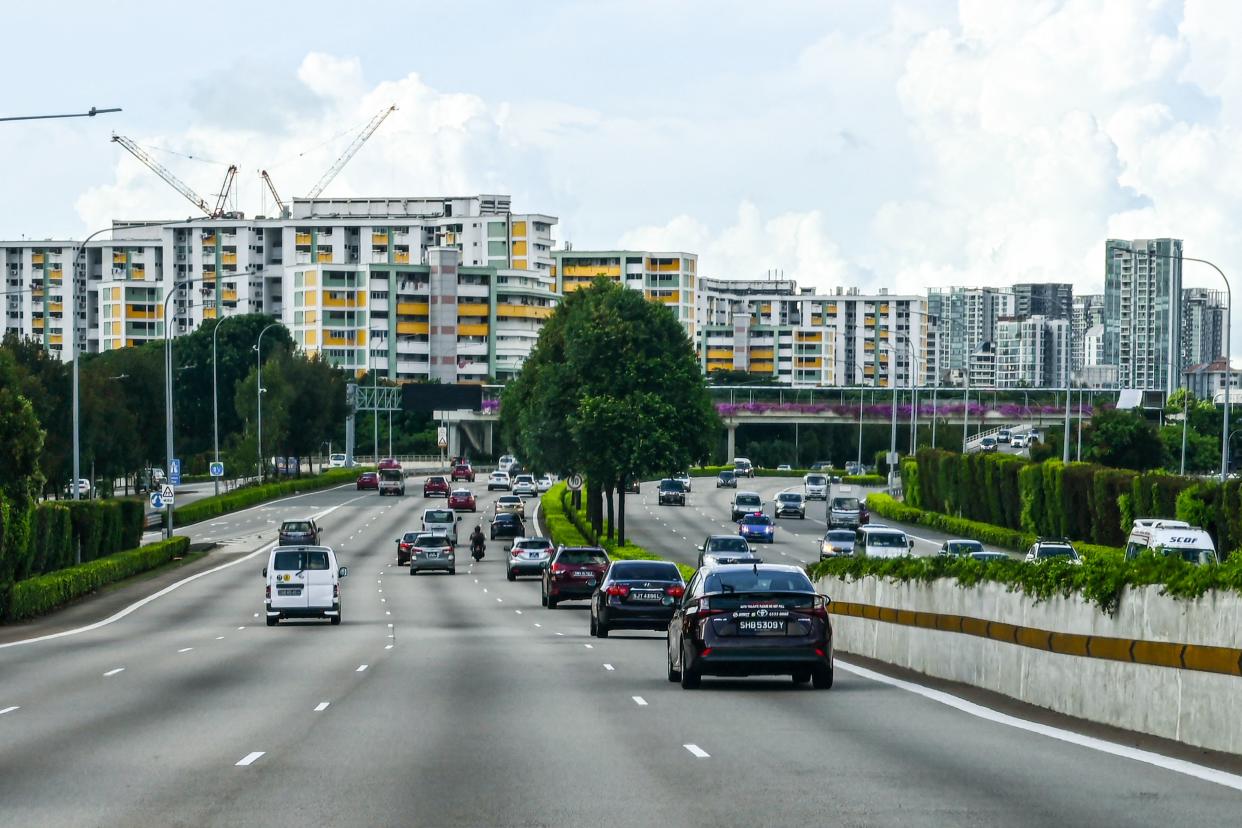 This photograph taken on June 14, 2021 shows motorists driving along the central expressway in Singapore. - A financial exchange offering carbon credits and investments in conservation projects is set to launch in Singapore, but it may struggle to convince sceptics of the value of controversial carbon offsets.  - TO GO WITH Singapore-market-climate, FOCUS by Martin Abbugao and Sam Reeves (Photo by Roslan RAHMAN / AFP) / TO GO WITH Singapore-market-climate, FOCUS by Martin Abbugao and Sam Reeves (Photo by ROSLAN RAHMAN/AFP via Getty Images)